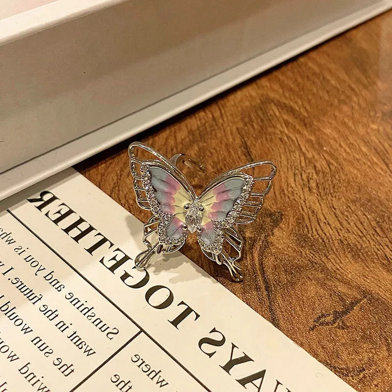 Copper butterfly women's ring with oil-drip finish showing open-loop design