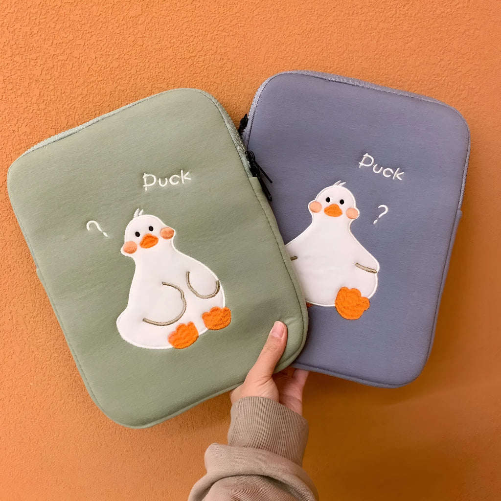 Blue cotton tablet case with embroidered cartoon duck design, zipper closed.