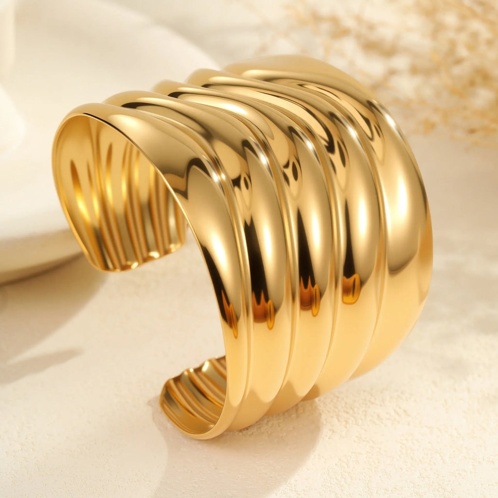 Gold plated wide women's bracelet with geometric wave design and niche opening