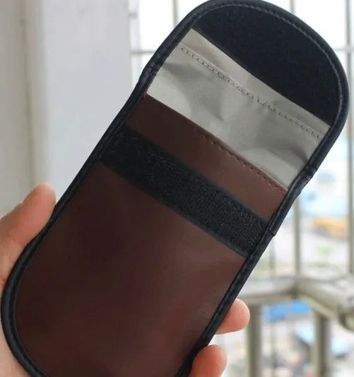 Black microfiber Faraday cage pouch for blocking car key fob and credit card signals.