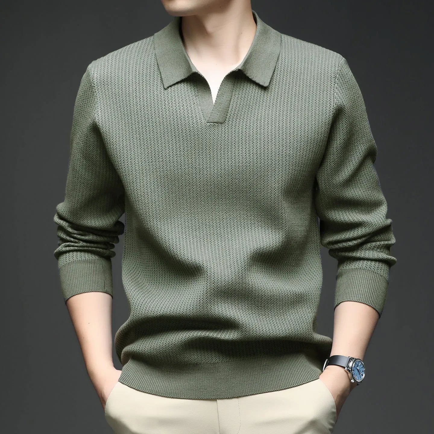 Men's loose green pullover sweater on a hanger, casual autumn wear
