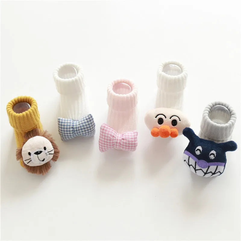 Cotton baby socks in multiple colours and prints including panda, lion, bows, and stars on a white background.