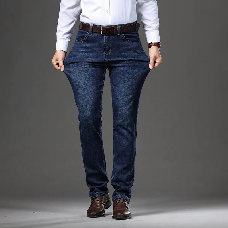 Women's loose fit, straight-leg stretch denim jeans in blue and black, showing zip fly and mid waist.