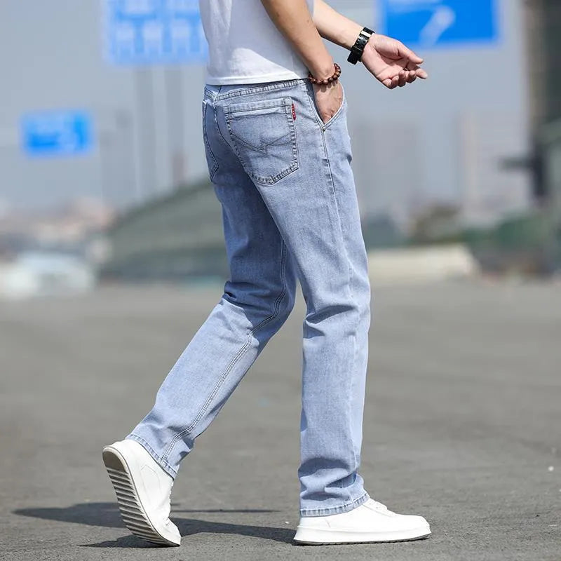 Men's straight-leg smoky gray jeans with low-rise waist and zip fly.