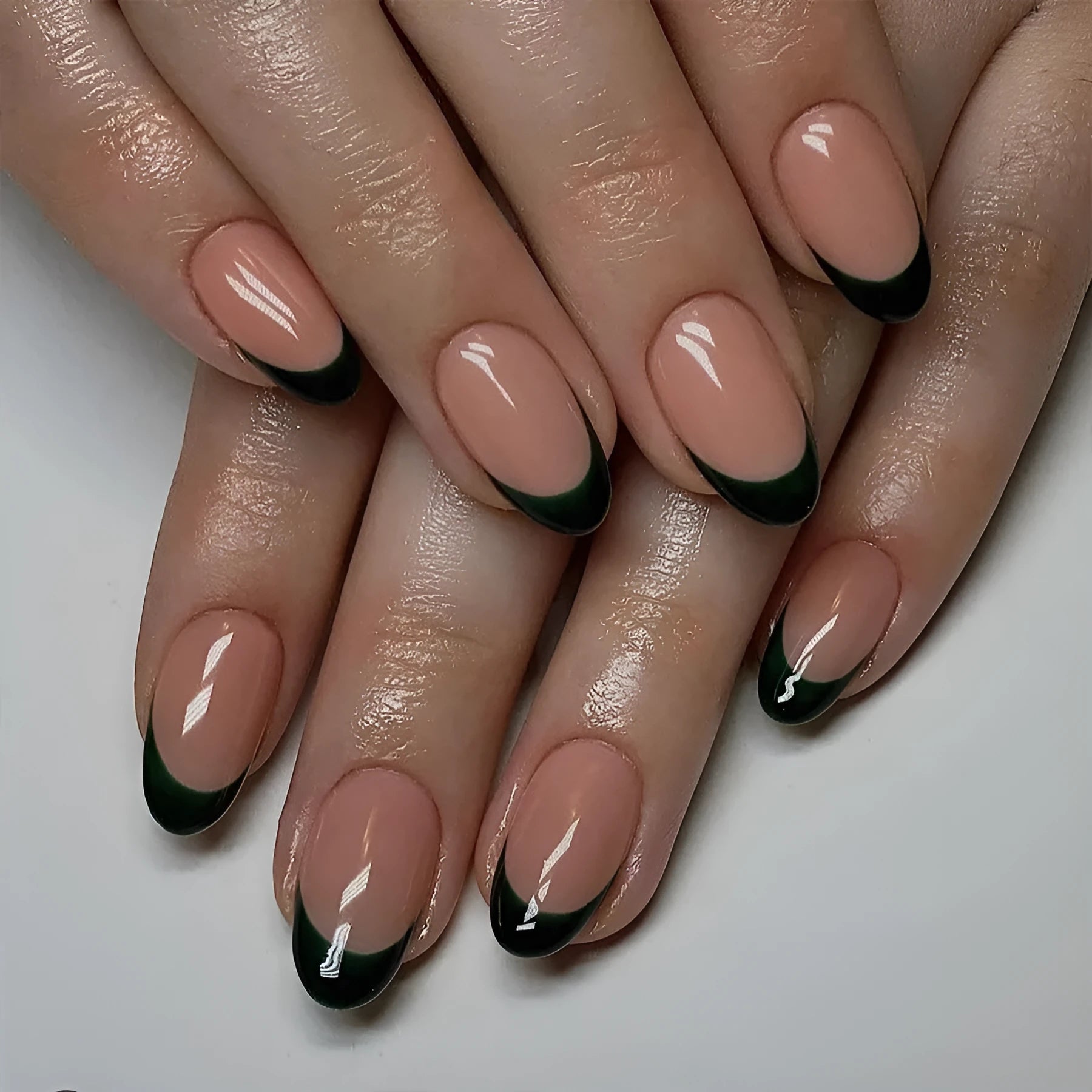 Set of 24 simple black French style false nails with a short almond shape on a clean background.