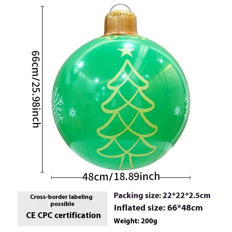 Large red and white inflatable Christmas ball with flashing lights in a garden setting.