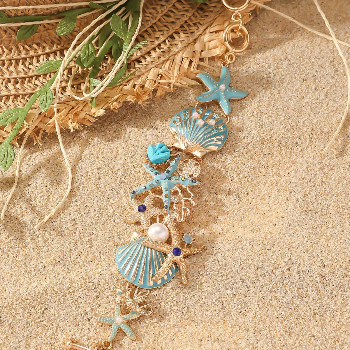 Women's alloy marine-themed bracelet with boat anchor, shells, starfish and rhinestones in turquoise, red or blue.