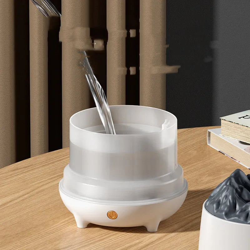 Volcano-shaped white humidifier with USB cable and mist rising from top