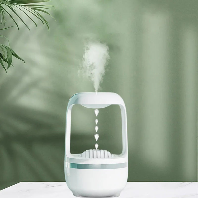 White anti-gravity humidifier showing floating water droplets on a desk next to a USB cable.