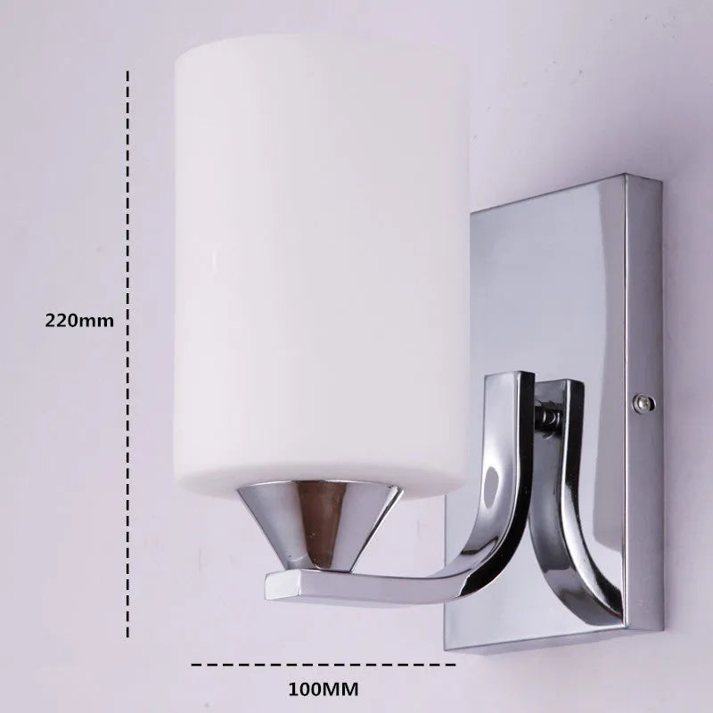 Modern chrome and glass wall lamp with single head design showing glass lampshade and metallic finish