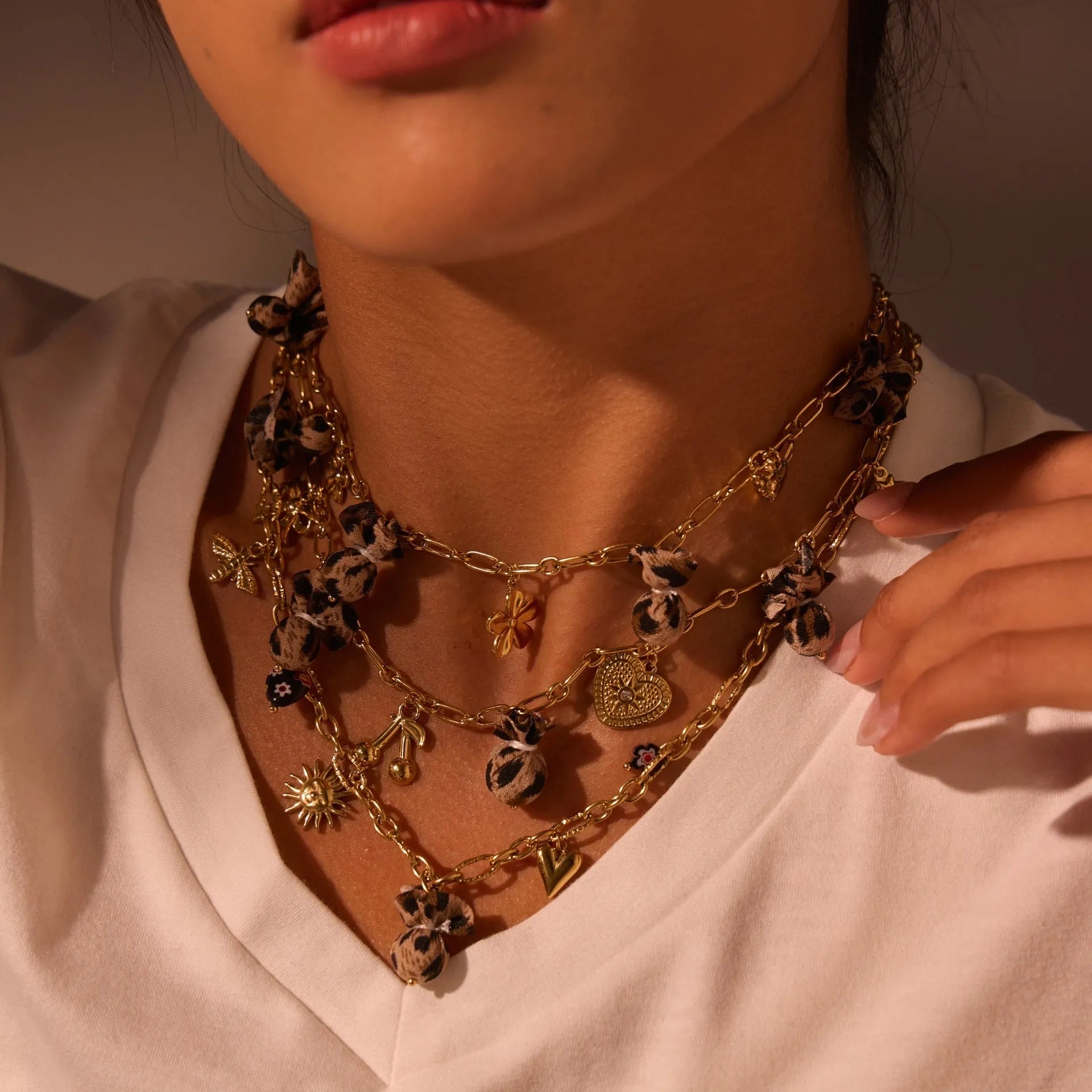 Gold plated stainless steel necklace with geometric leopard, love heart, and flowers pendant on a regular chain.