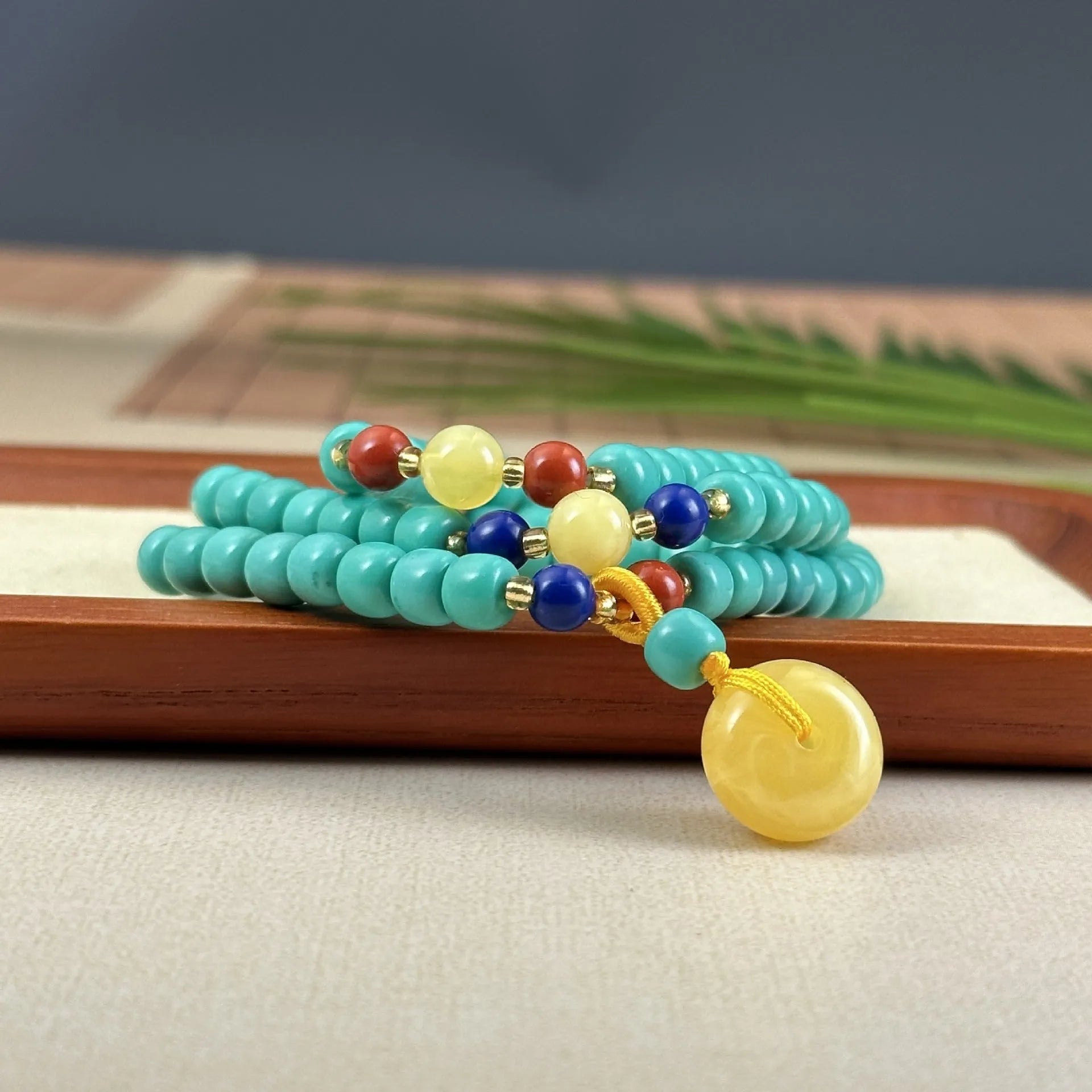 Turquoise stone mesh flower pendant on a silver ball bead necklace, adjustable length.