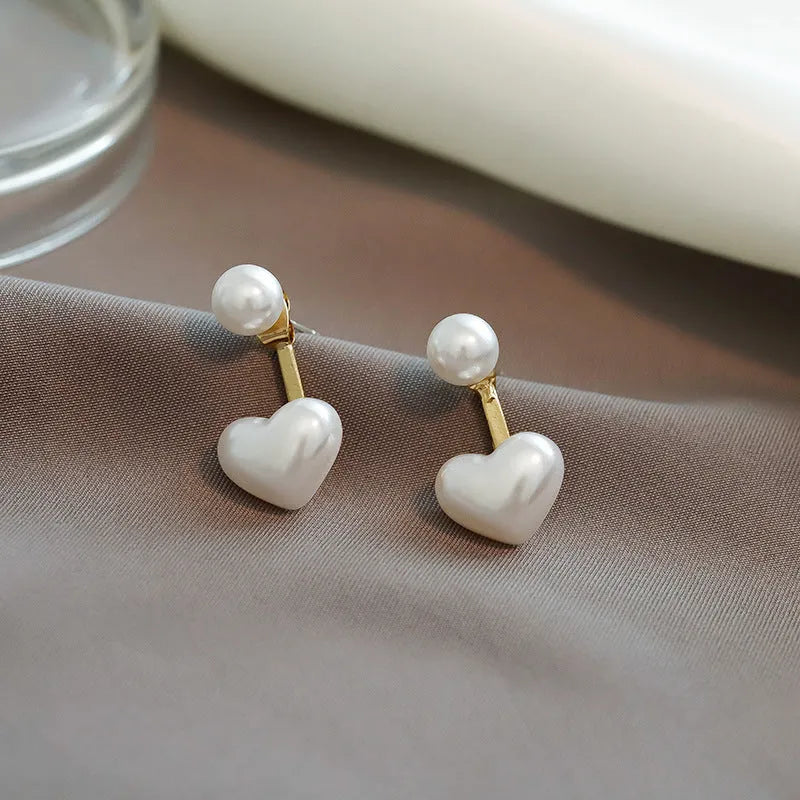 Heart-shaped pearl stud earrings with alloy settings and electroplated metallic finish
