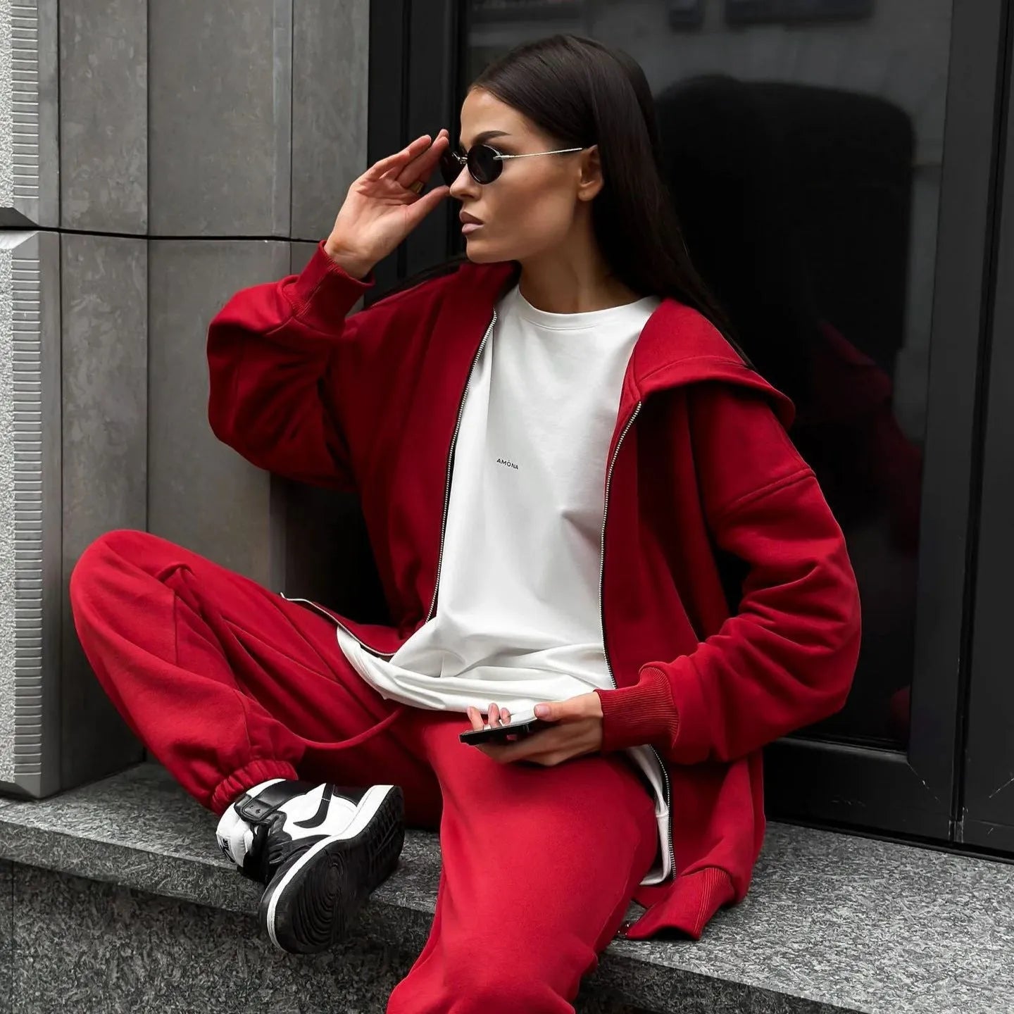 Red loose fit street style two-piece set with long sleeve coat and trousers on a rack