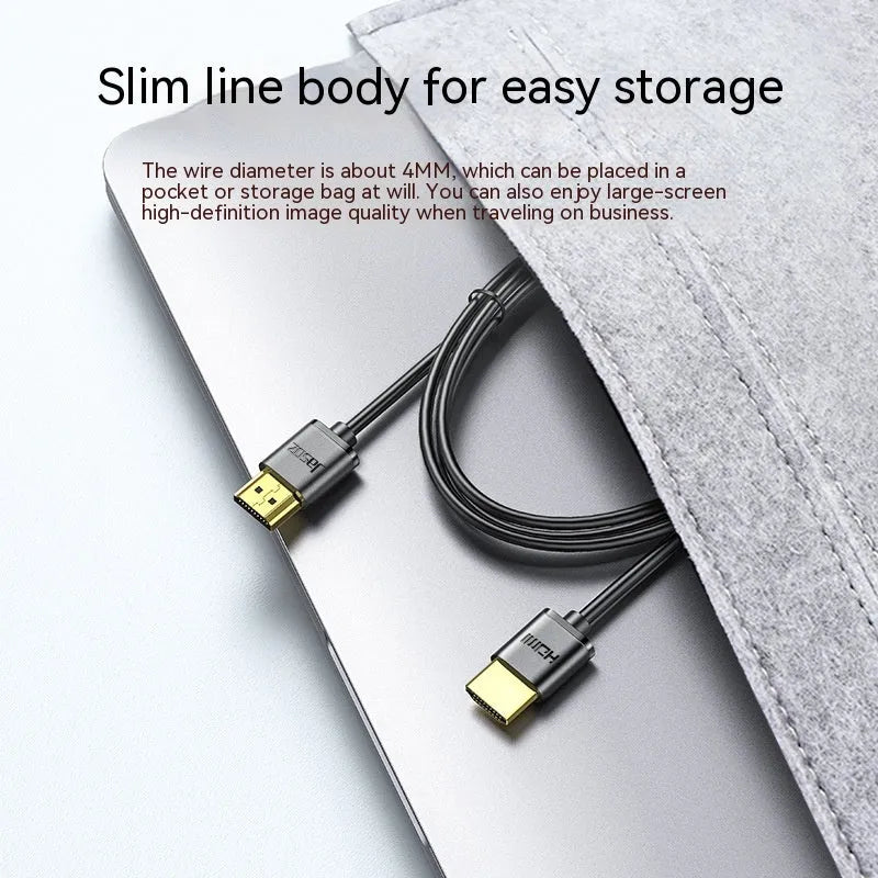 Flexible thin HDMI cable with gold-plated connectors and HDMI hairline rule design on a white background.