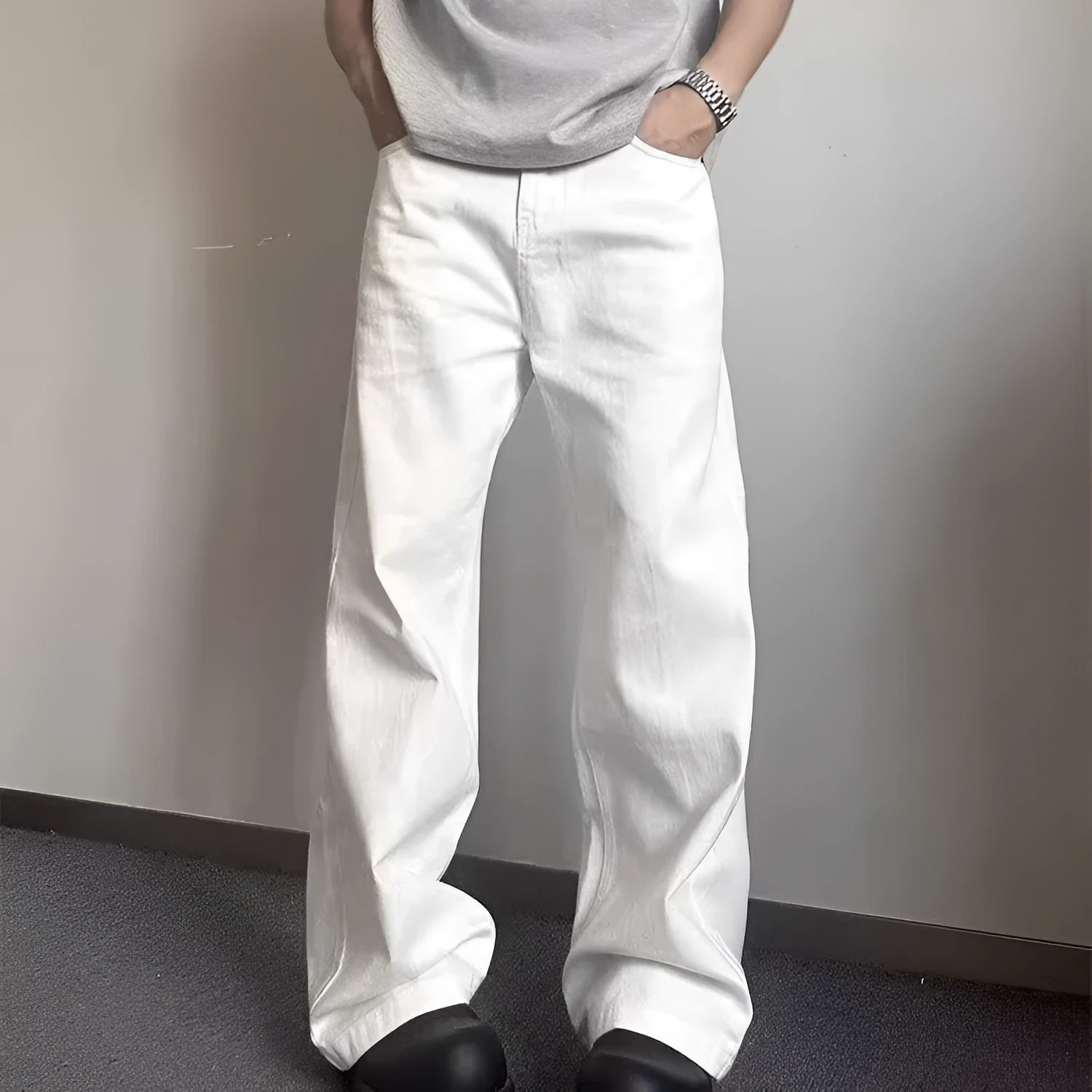 Men's white loose straight-leg jeans with wide leg openings and mid-waist design