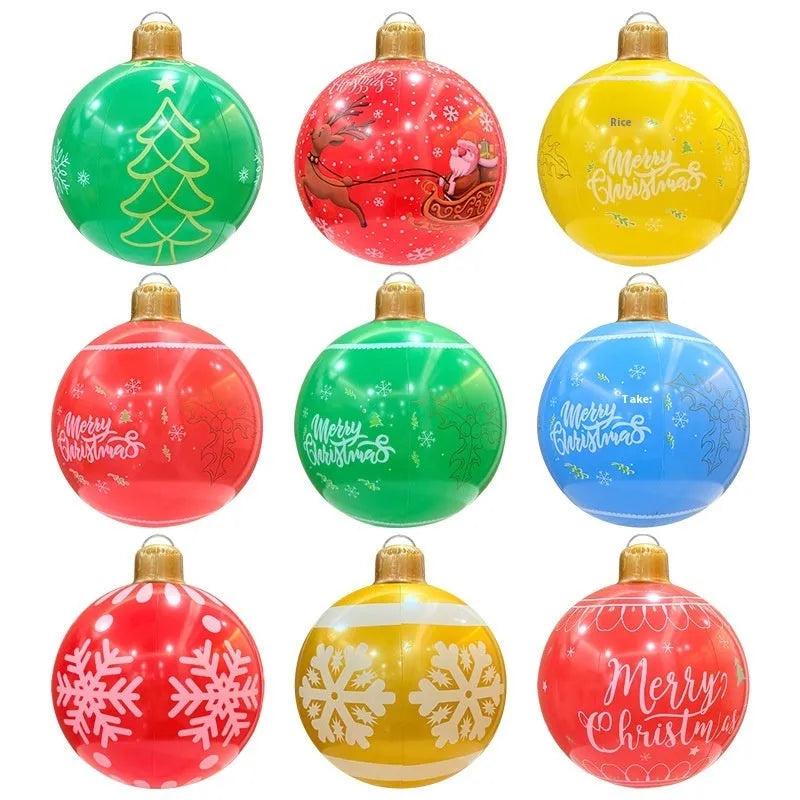 Large red and white inflatable Christmas ball with flashing lights in a garden setting.