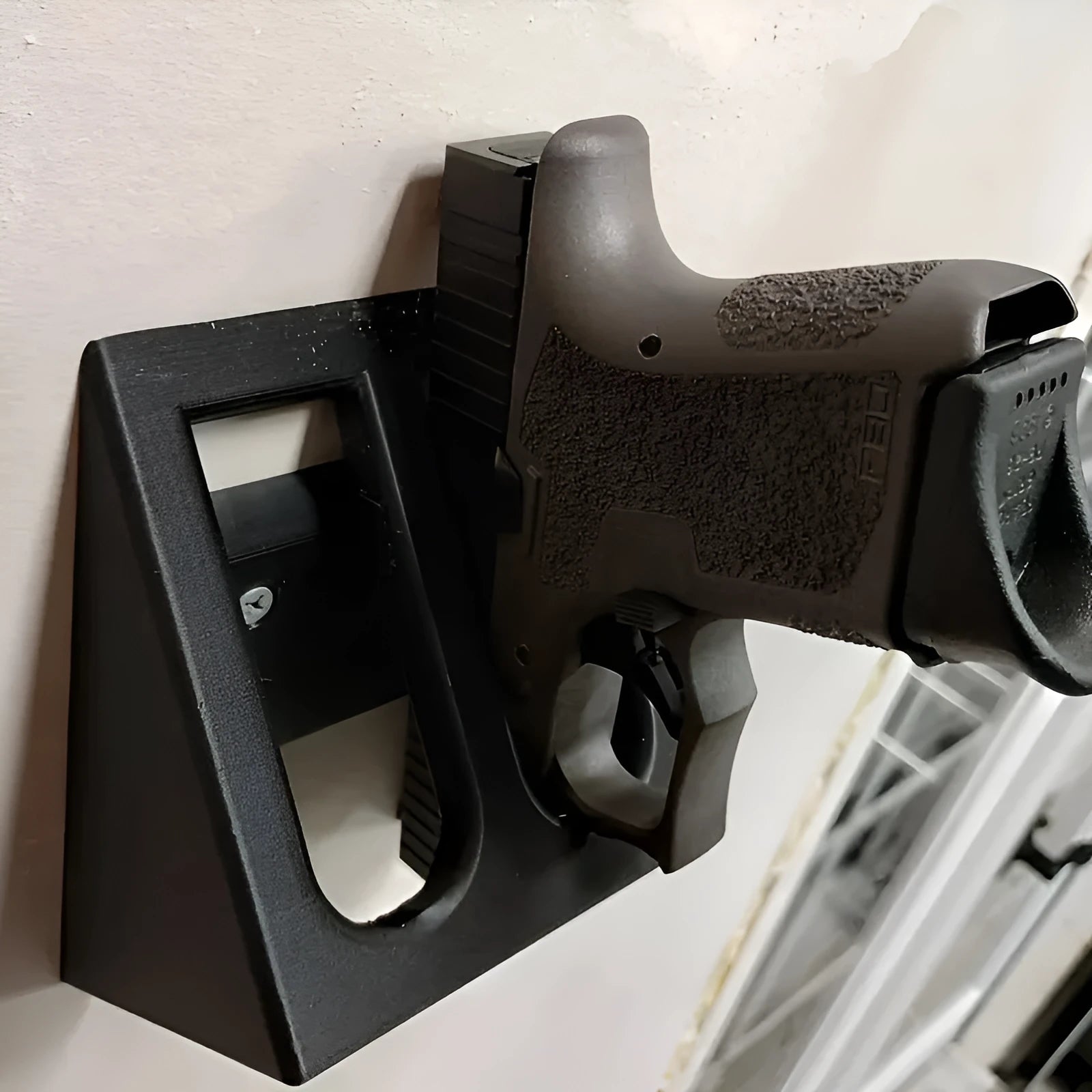 Black punk-style plastic pistol stand for firearm storage and display