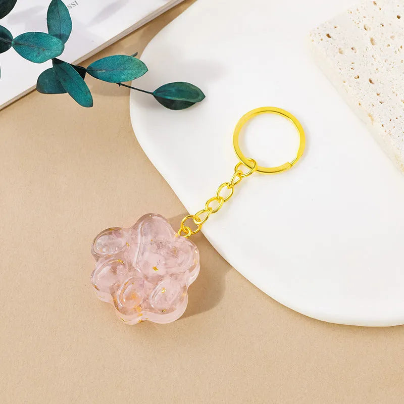 Small natural crystal cat's paw claw charm on a metal loop keychain