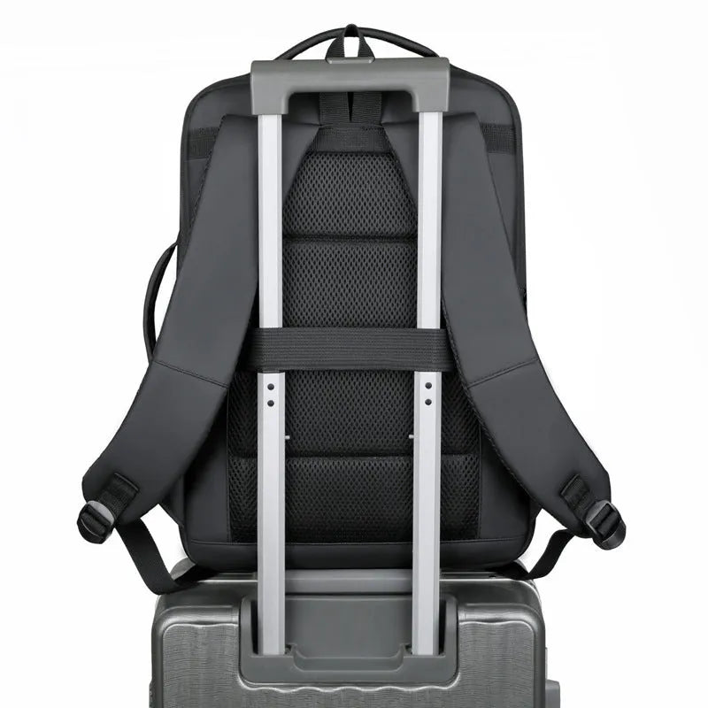 Black Oxford cloth waterproof backpack with curved shoulder strap, shown with a laptop compartment open.