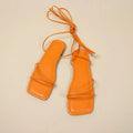Women's white ankle ring bandage cloth flat sandals with front lace-up and square toe on a rubber sole.