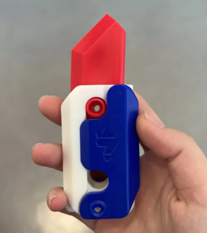 Carrot-shaped 3D printed plastic gravity fidget knife with orange purple green colour scheme