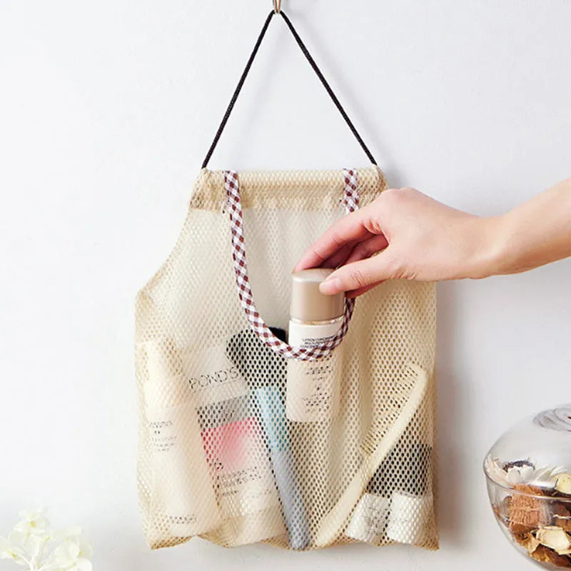 Beige plaid polyester mesh kitchen storage bag with cotton rope loops on a wall hook, 26x29cm