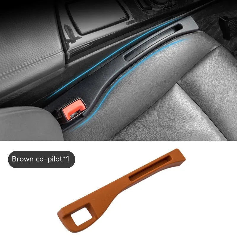 Black plastic car seat gap storage organiser box with handle inserted between car seat and centre console.