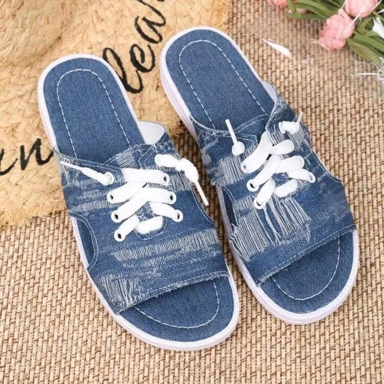 Blue canvas Roman-style slippers for women with a rubber sole.