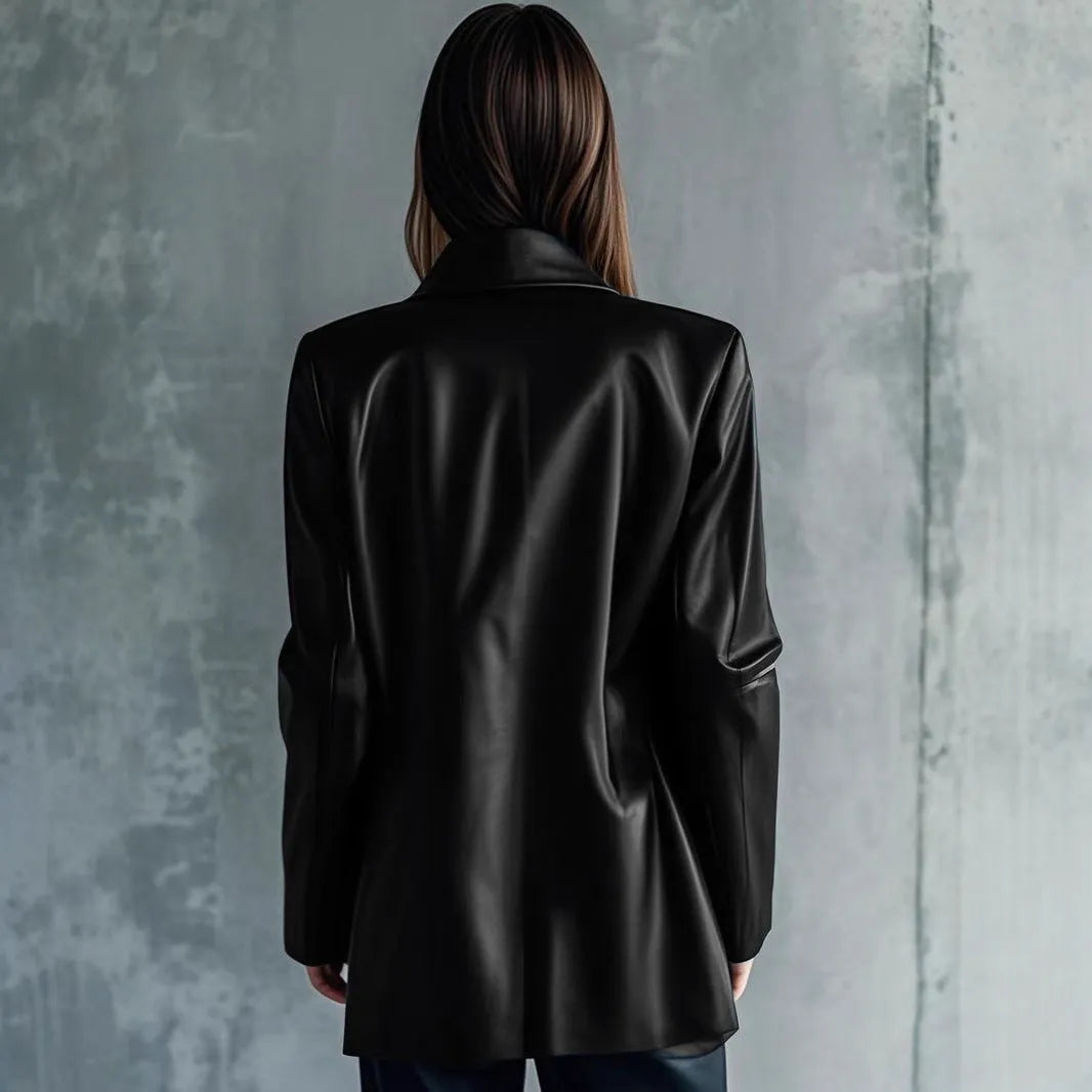 Black polyester women's leather jacket with long sleeves on a hanger.