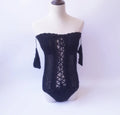 Off-shoulder one-piece swimsuit in polyester fabric on mannequin