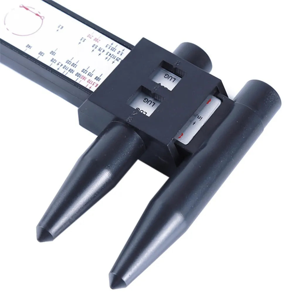 Digital hole distance measuring tool with electronic display, plastic caliper body shown next to a ruler for scale.