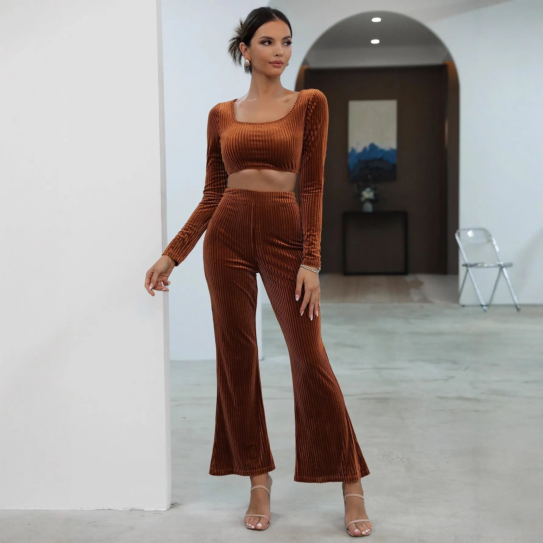 Caramel coloured women's long sleeve sweater and loose trouser co-ord set on a hanger