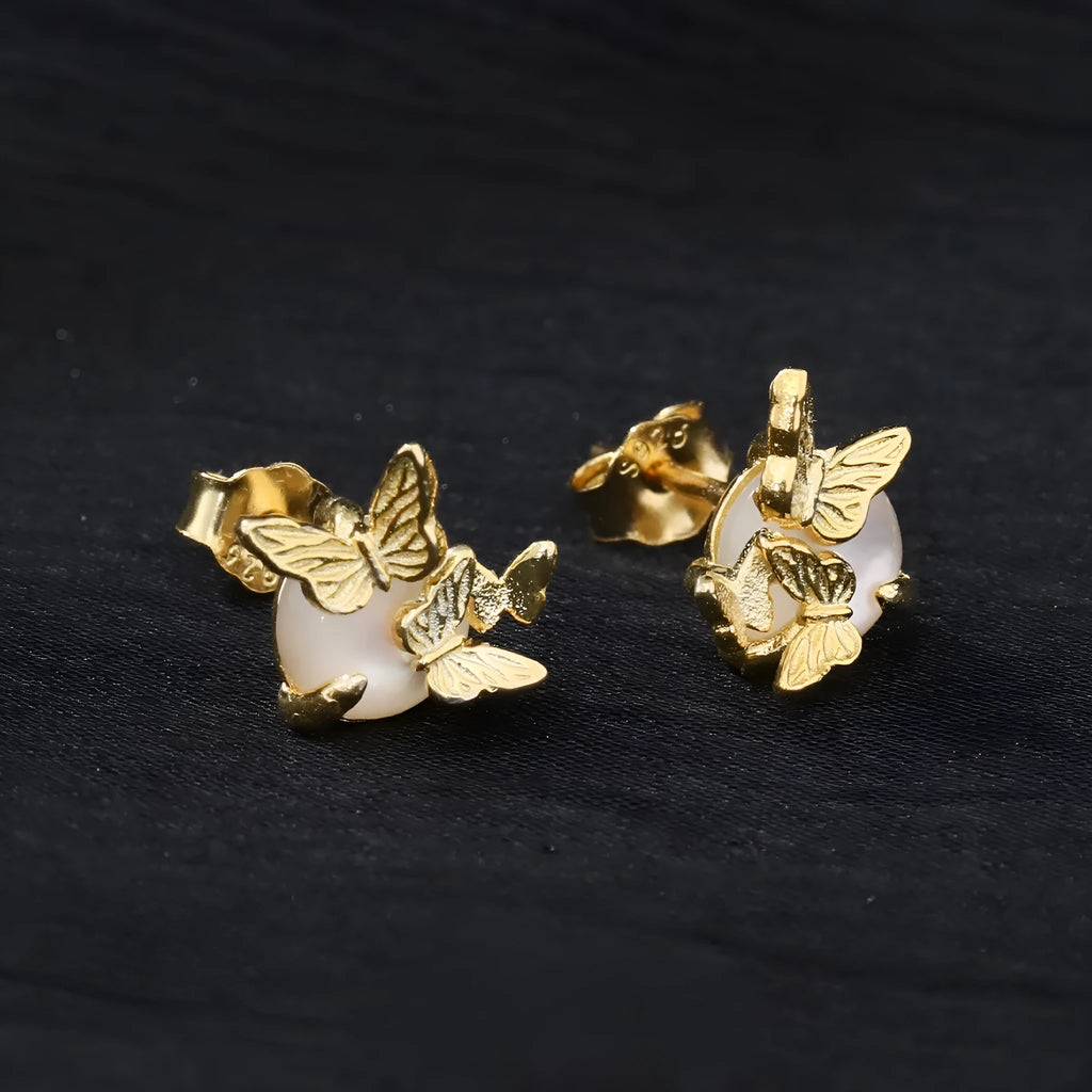 A pair of 925 silver butterfly ear studs with an original animal design, shown in gold and white gold colour finishes.