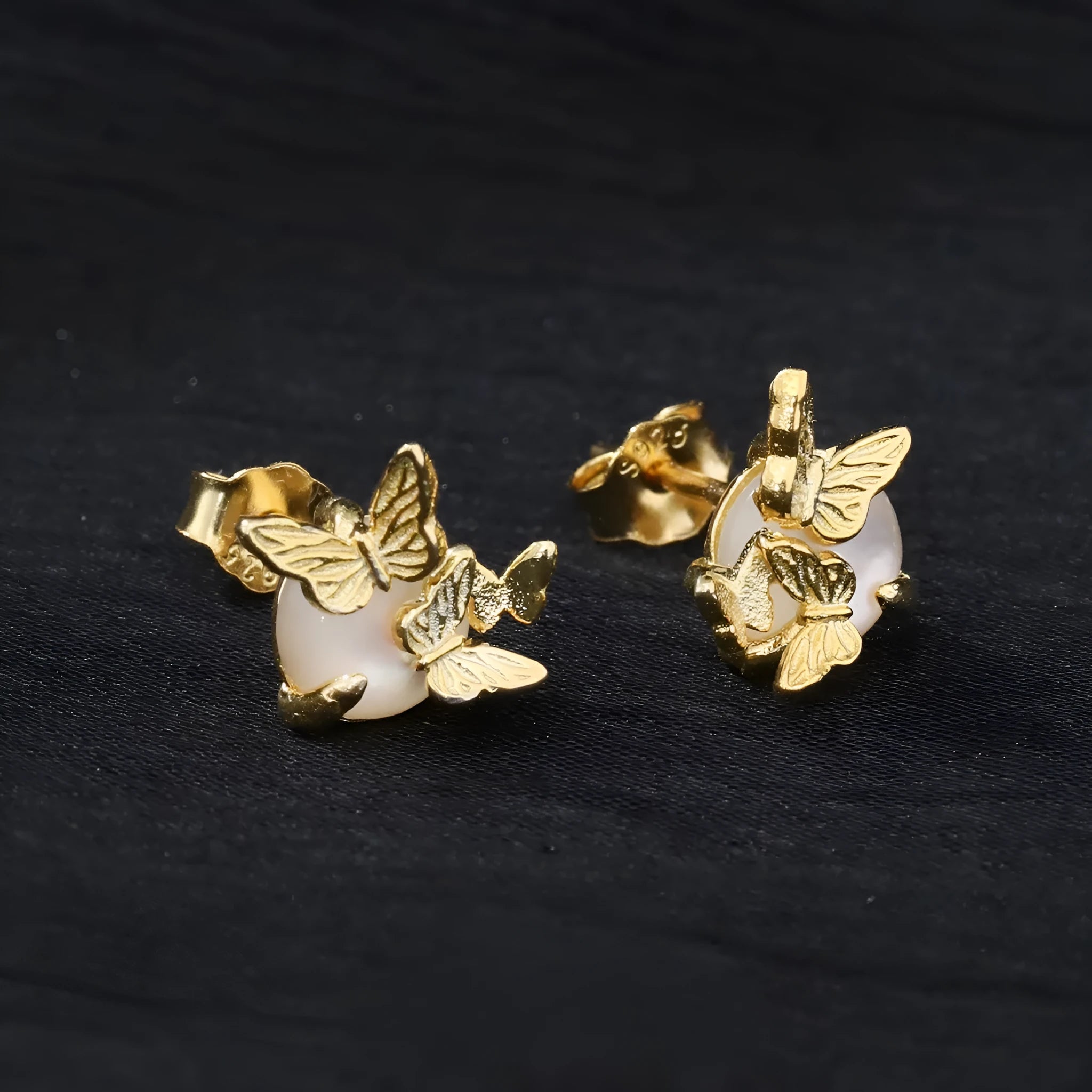 A pair of 925 silver butterfly ear studs with an original animal design, shown in gold and white gold colour finishes.
