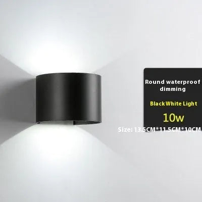 Modern black wall lamp with aluminium body, clear glass shade, and silicone rubber accents.