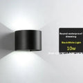 Modern black wall lamp with aluminium body, clear glass shade, and silicone rubber accents.
