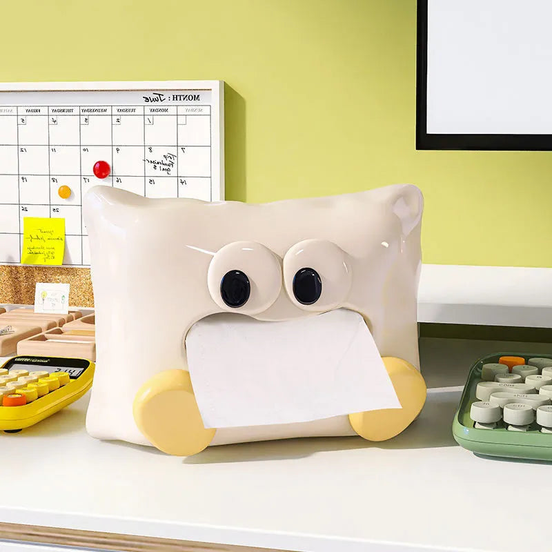 White ceramic square tissue box holder with polished glazed finish on a living room coffee table