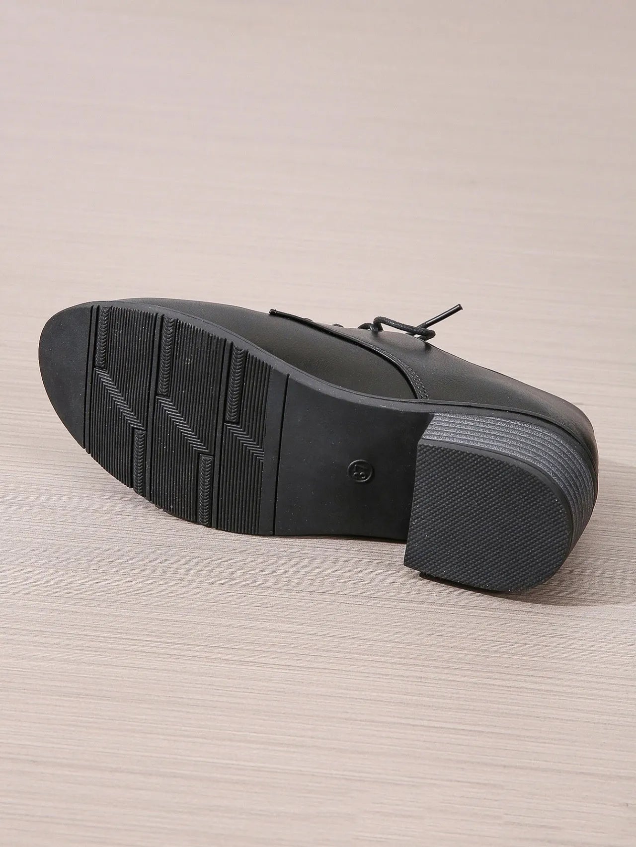 Black women's low-top work shoes with a chunky heel, rounded toe, and soft rubber sole.