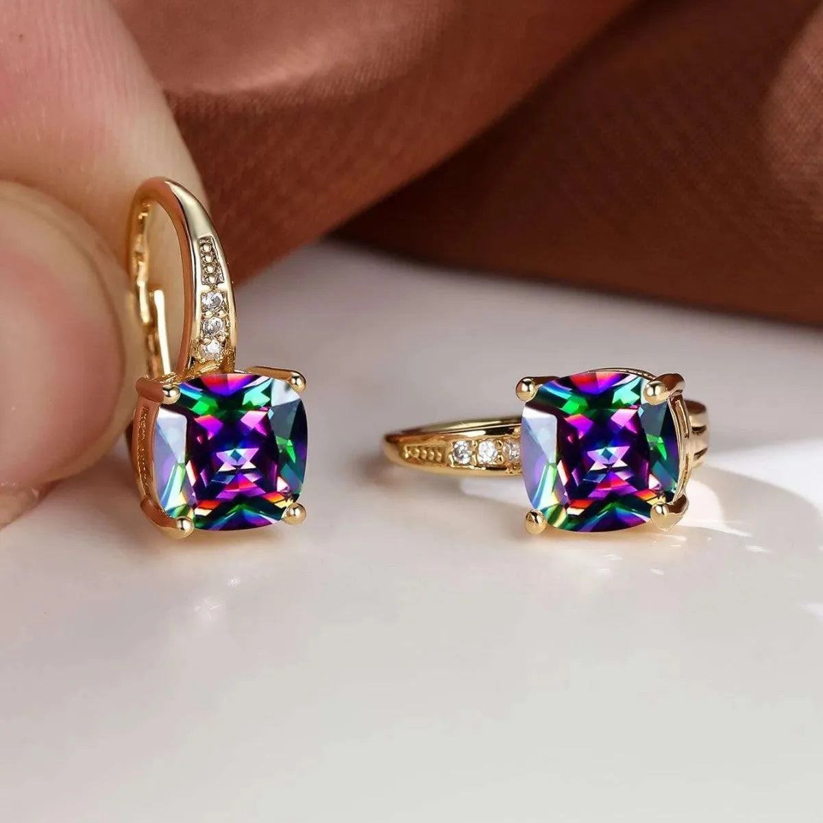 Square geometric ear clip with colourful moissanite inlay on an electroplated copper base.