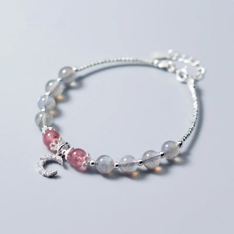 Natural moonstone bracelet with extension chain showing crescent moon and crystal accents