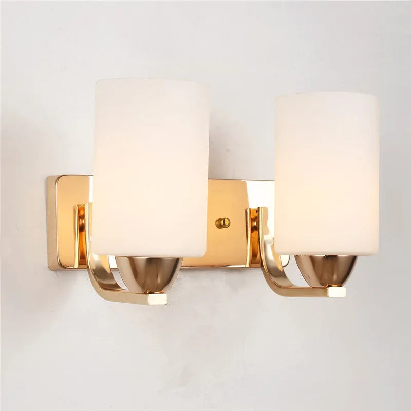 Modern chrome and glass wall lamp with single head design showing glass lampshade and metallic finish