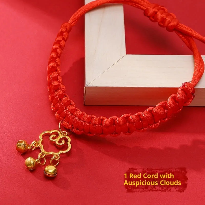 Adjustable hand-woven red rope pet collar with alloy lucky charm on wooden surface