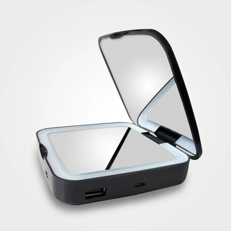 Black and white lighted makeup mirror with 4x magnification lens and adjustable LED lighting