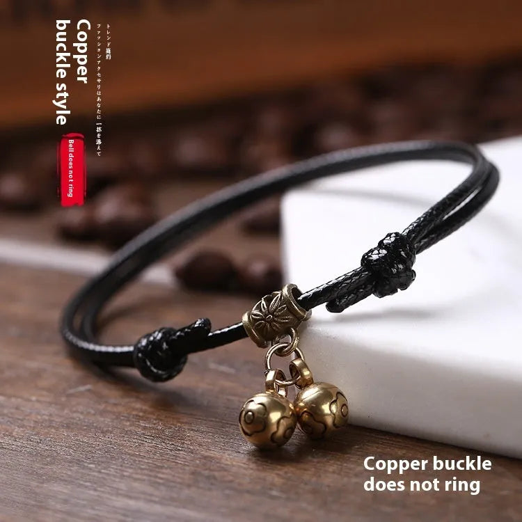 Adjustable nylon dog collar with brass bell, shown in black rope colour on a size chart.