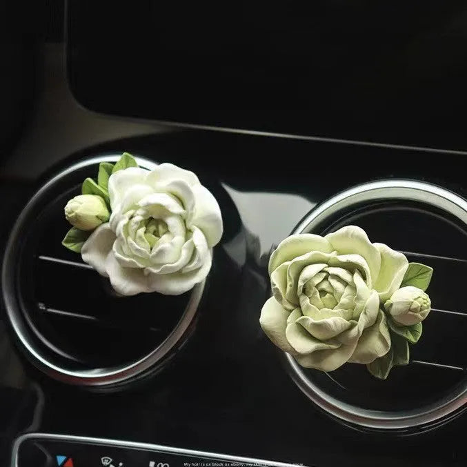 Solid gypsum car air freshener diffuser in air vent with jasmine fragrance oil.