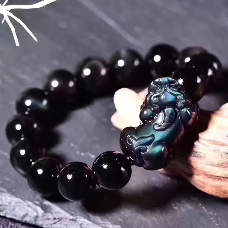Natural ice colour polished obsidian crystal bracelet with adjustable closure on a wrist.