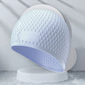 Silicone adult swimming cap with water drop pattern in solid colour options.