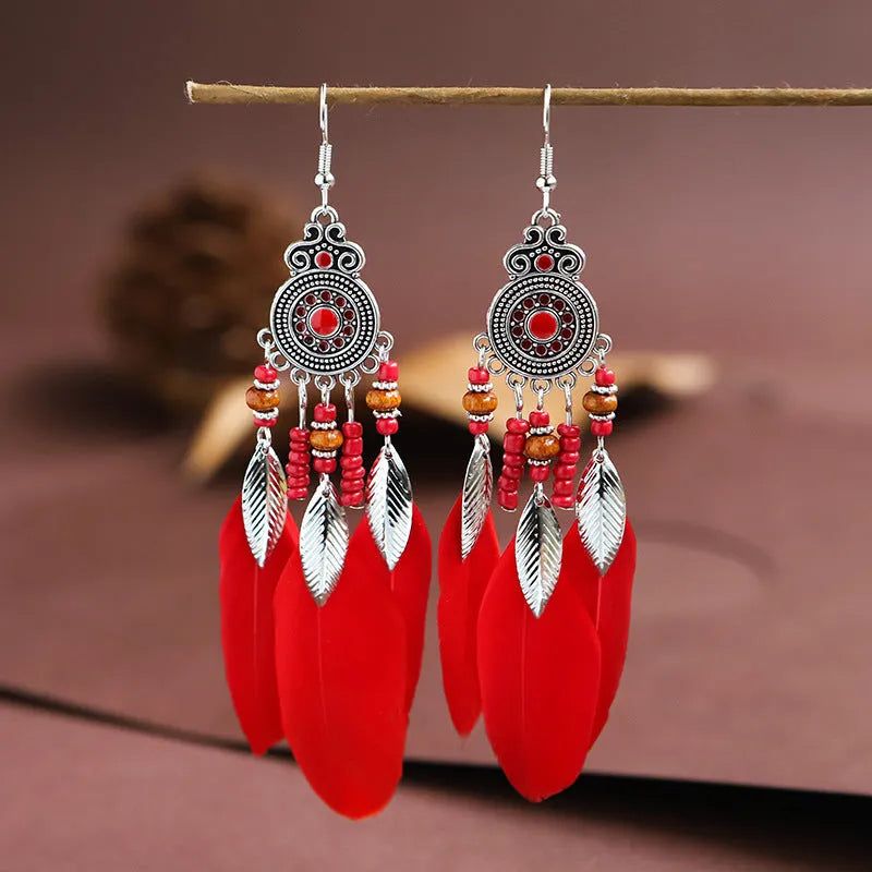 Round drop feather earrings with leaf patterning in alloy, available in multiple electroplated colours.