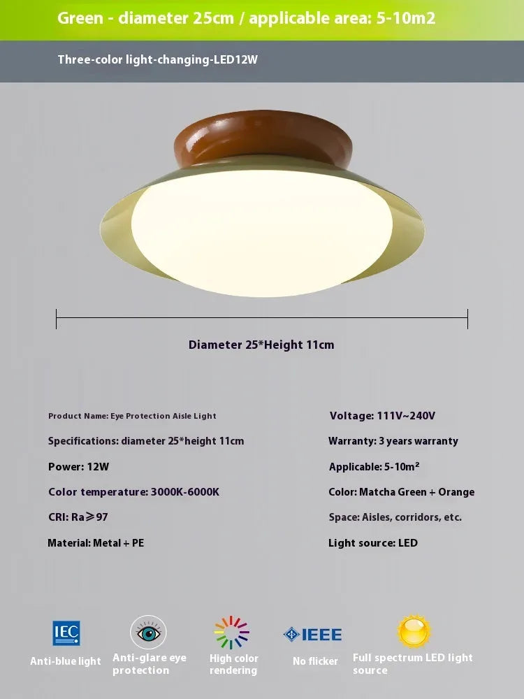 Modern minimalist cream style flying saucer ceiling lamp in mint green on a white ceiling.